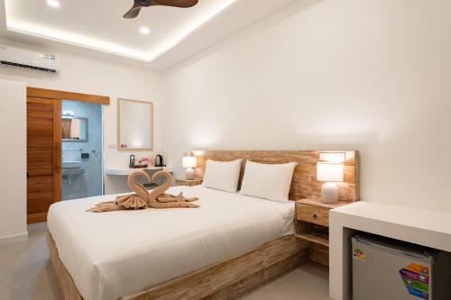 a bedroom with a bed with a heart decoration on it at Eden Extend Fisherman's village in Koh Samui 