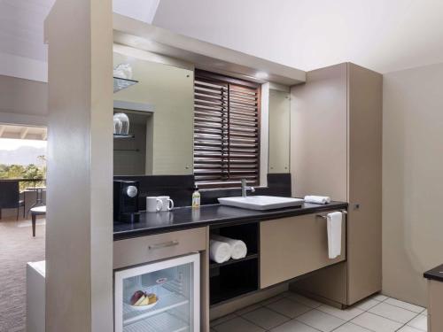 a kitchen with a counter and a sink at Novotel Nadi in Nadi