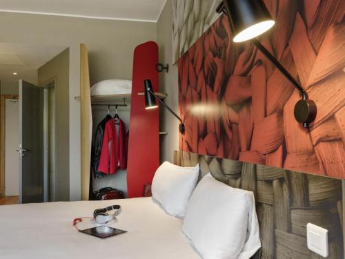 a bedroom with a white bed with a wooden wall at Ibis Casablanca Sidi Maarouf in Casablanca