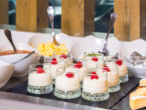 a buffet with cakes and desserts on a table at Ibis Casablanca Sidi Maarouf in Casablanca