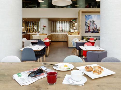 a table with plates of food on it in a restaurant at Ibis Casablanca Sidi Maarouf in Casablanca
