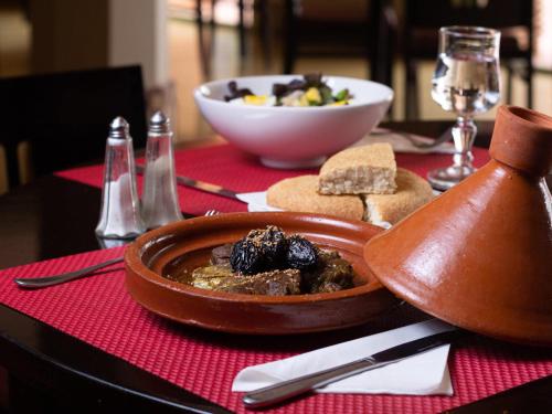 a bowl of food on a table with a bowl of food at Ibis Marrakech Palmeraie in Marrakech