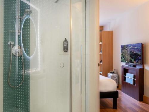 a shower with a glass door in a bathroom at Ibis Madrid Alcobendas in Alcobendas