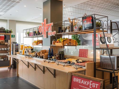 a bakery with a counter with food on it at Ibis Madrid Alcobendas in Alcobendas