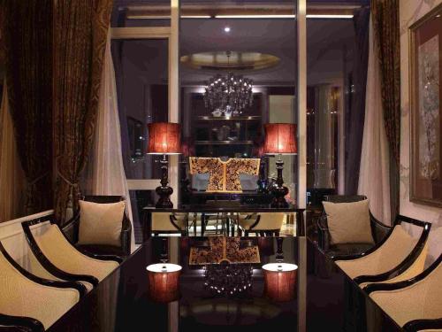 a room with a table and chairs and a chandelier at Sofitel Guangzhou Sunrich - Free Shuttle Bus to Canton Fair Complex & Overseas Buyer Registration Services during Canton Fair Period in Guangzhou