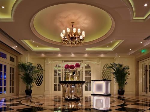 a large room with a ceiling with a chandelier at Sofitel Guangzhou Sunrich - Free Shuttle Bus to Canton Fair Complex & Overseas Buyer Registration Services during Canton Fair Period in Guangzhou