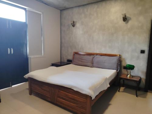 a bed in a room with a window and a bed sidx sidx sidx at Bali Mantra in New Delhi
