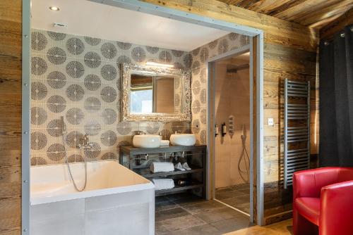 a bathroom with a tub and two sinks at Black Diamond - Chalet Tango in Les Brévières