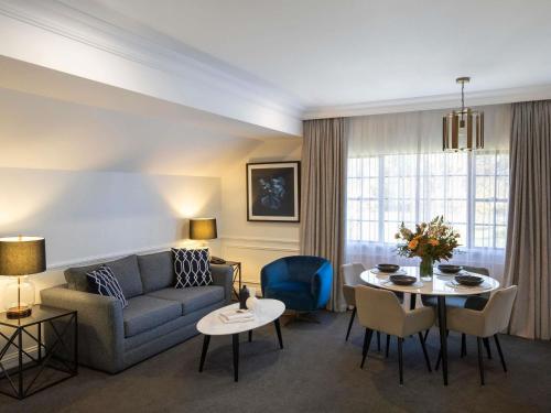 a living room with a couch and a table at Peppers The Hills Lodge in Castle Hill