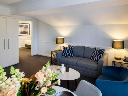 a living room with a couch and a table at Peppers The Hills Lodge in Castle Hill