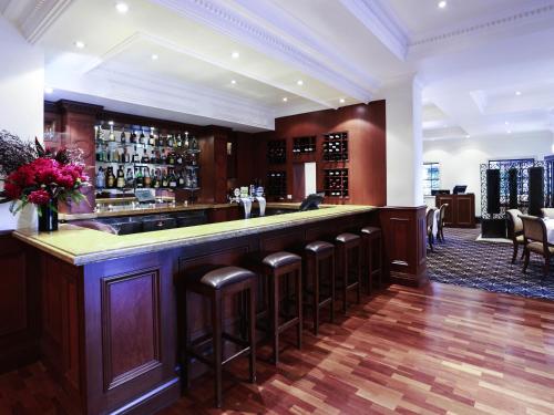 a bar with a bunch of stools in a room at Peppers The Hills Lodge in Castle Hill