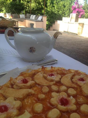 a table with a tea pot and a plate of food at Castello di Casamassella - Marea Stays Collection in Casamassella