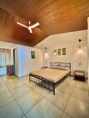a bedroom with a bed with a ceiling at Shalgar Villa The Homestay in Satara