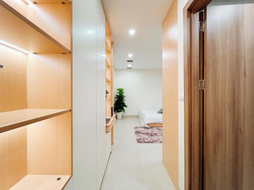 a hallway with a closet and a bed in a room at Soin Riverside Apartment in Hanoi