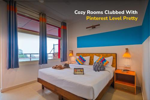 a bedroom with a large bed with a window at goSTOPS Mcleodganj Dalailama Temple in Dharmsala