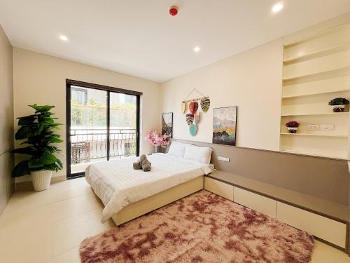 a bedroom with a bed and a large window at Soin Riverside Apartment in Hanoi