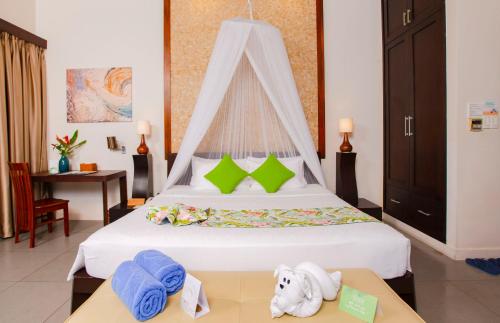 a bedroom with a large bed with towels on a table at The Cliff Resort & Residences in Mui Ne