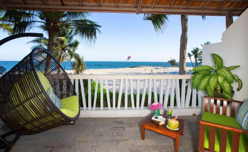 a porch with a hammock and a view of the beach at The Cliff Resort & Residences in Mui Ne