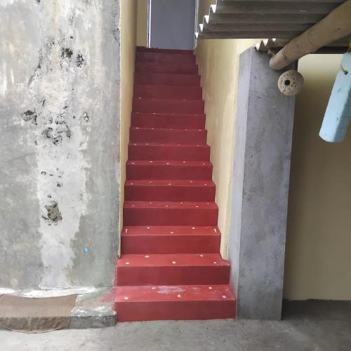 a red staircase with red steps in a building at Inuli Coco Hut in Kalutara