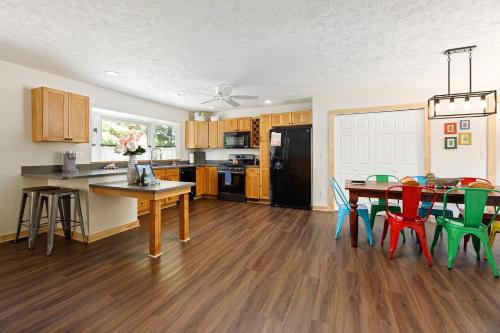 a kitchen and dining room with a table and chairs at Dyer Lake Gallery Retreat - Lakefront - Deck - Fire Pit in Grawn
