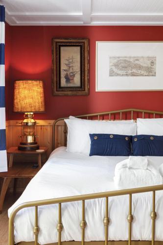 a bedroom with red walls and a bed at Dyer Lake Gallery Retreat - Lakefront - Deck - Fire Pit in Grawn