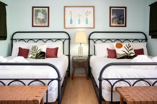 two beds in a room with blue walls at Dyer Lake Gallery Retreat - Lakefront - Deck - Fire Pit in Grawn