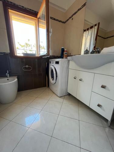 a bathroom with a washing machine and a sink at Appartamento Cavour in Ventimiglia