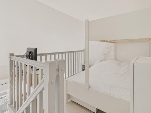 a white bunk bed in a white room at Appartement avec piscine commune pour 4 in Guérande