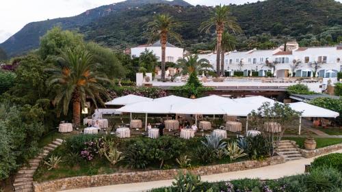 an aerial view of a resort with tables and umbrellas at Le Calette N.5 in Cefalù