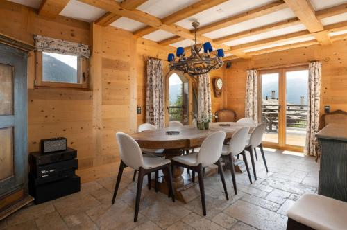 a dining room with a table and chairs at Chalet Jenna Verbier - by EMERALD STAY in Verbier