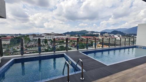 a swimming pool on the roof of a building at Hotel Seri Warisan in Taiping
