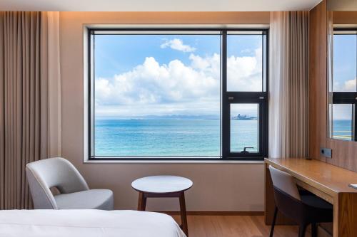 a hotel room with a view of the ocean at Pohang Yeongildae Beach Hotel in Pohang