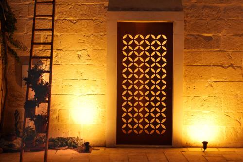 a door with a light on the side of a building at Masseria Luci Grande in Scorrano
