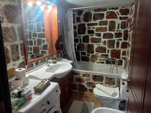 a bathroom with a stone wall at Villa Despoina in Amarinthos
