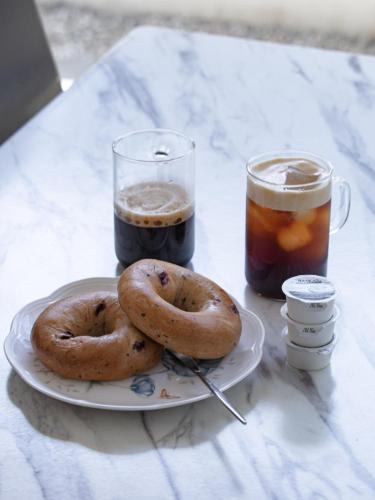 two bagels on a plate on a table with drinks at Eosahwa in Jeonju