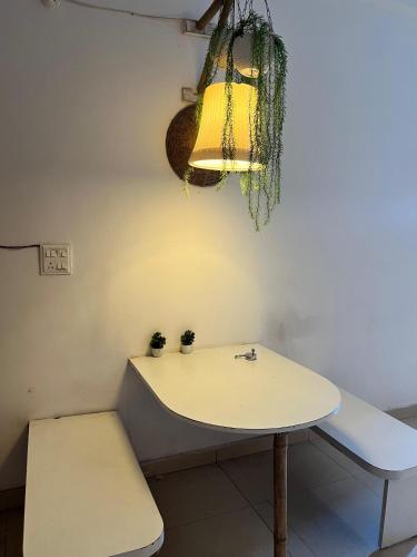 a table and a bench in a room at The Boho nest near ganges in Rishīkesh