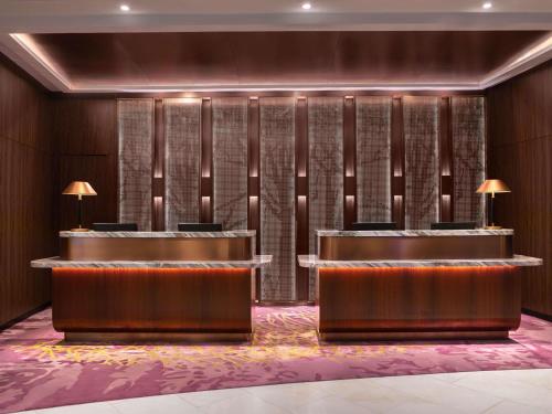 a hotel lobby with a row of desks at Novotel Kuala Lumpur City Centre in Kuala Lumpur