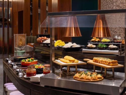 a buffet line with many different types of food at Novotel Kuala Lumpur City Centre in Kuala Lumpur