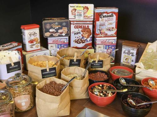 a table topped with bags of cereals and other food at ibis Kortrijk Centrum in Kortrijk