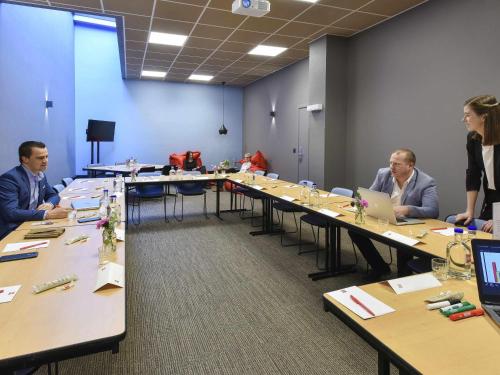a group of people sitting at tables in a room at ibis Kortrijk Centrum in Kortrijk