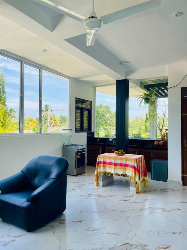 a living room with a couch and a table at Ominiyet Villa in Galle