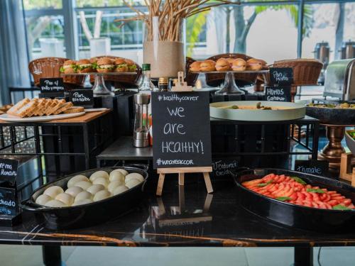 a buffet with bread and pastries and other food at Novotel Lima San Isidro in Lima