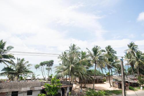 a view of a village with palm trees at Buddy's Place in Ambalangoda