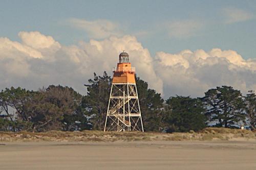 a light house on the shore of a beach at The Station House Motel in Collingwood