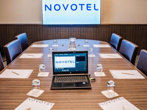a laptop computer sitting on top of a table at Novotel Lima San Isidro in Lima