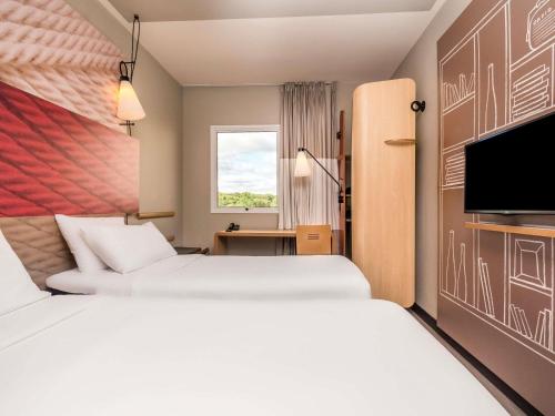 Ένα ή περισσότερα κρεβάτια σε δωμάτιο στο ibis Campo Grande