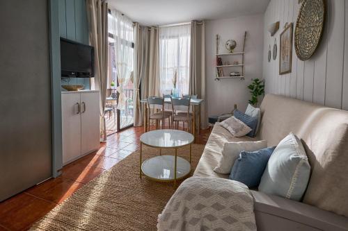 a living room with a couch and a table at Casa Amaore La Gomera in Playa de Santiago