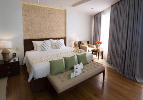 a bedroom with a large bed and a couch at The Cliff Resort & Residences in Mui Ne