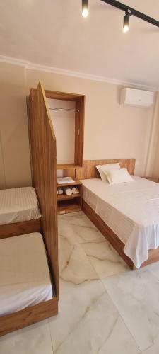 a bedroom with two bunk beds and a tiled floor at Hotel Lalez Durres in Durrës