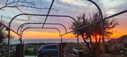 a van parked in a parking lot with a sunset in the background at Hotel Lalez Durres in Durrës